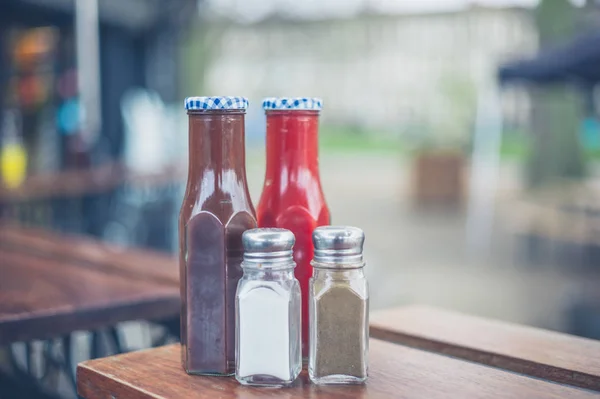 Condiments with salt and pepper — Stock Photo, Image