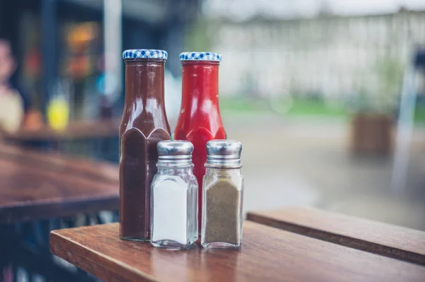 Condiments with salt and pepper — Stock Photo, Image