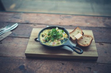 Pencerenin yanında ekmek ile bir tavada omlet