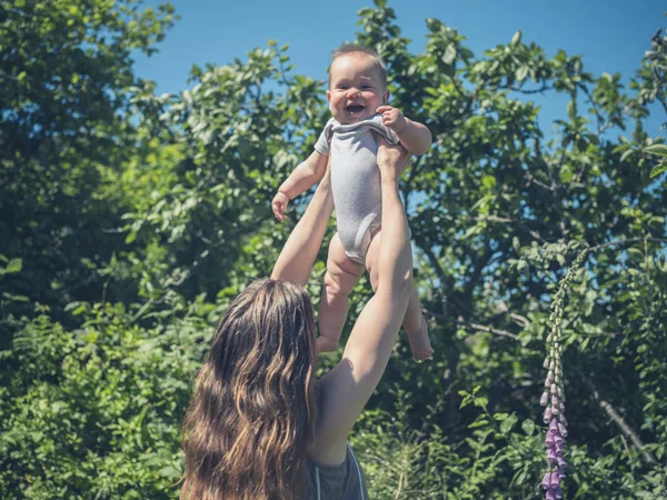 Young Mother Lifting Her Baby Air Nature — Stock Photo, Image