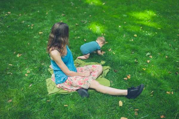 Madre con bebé en el parque en el día de verano — Foto de Stock