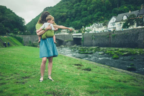 Anne ile bebek nehir tarafından işaret ediyor — Stok fotoğraf