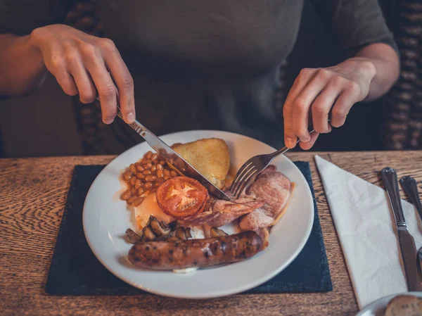 Young woman having traditional english breakfast — Stock Photo, Image