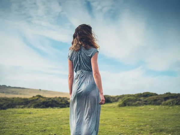 Beautiful young woman in dress on the moor — Stock Photo, Image