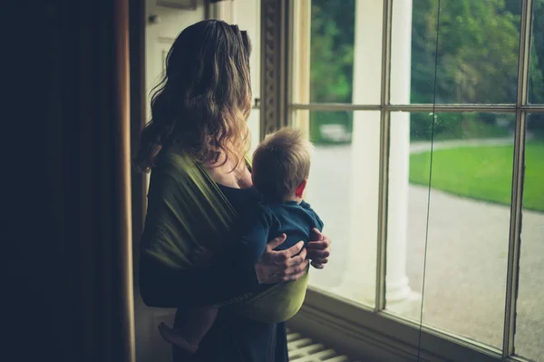 Mother with baby by window