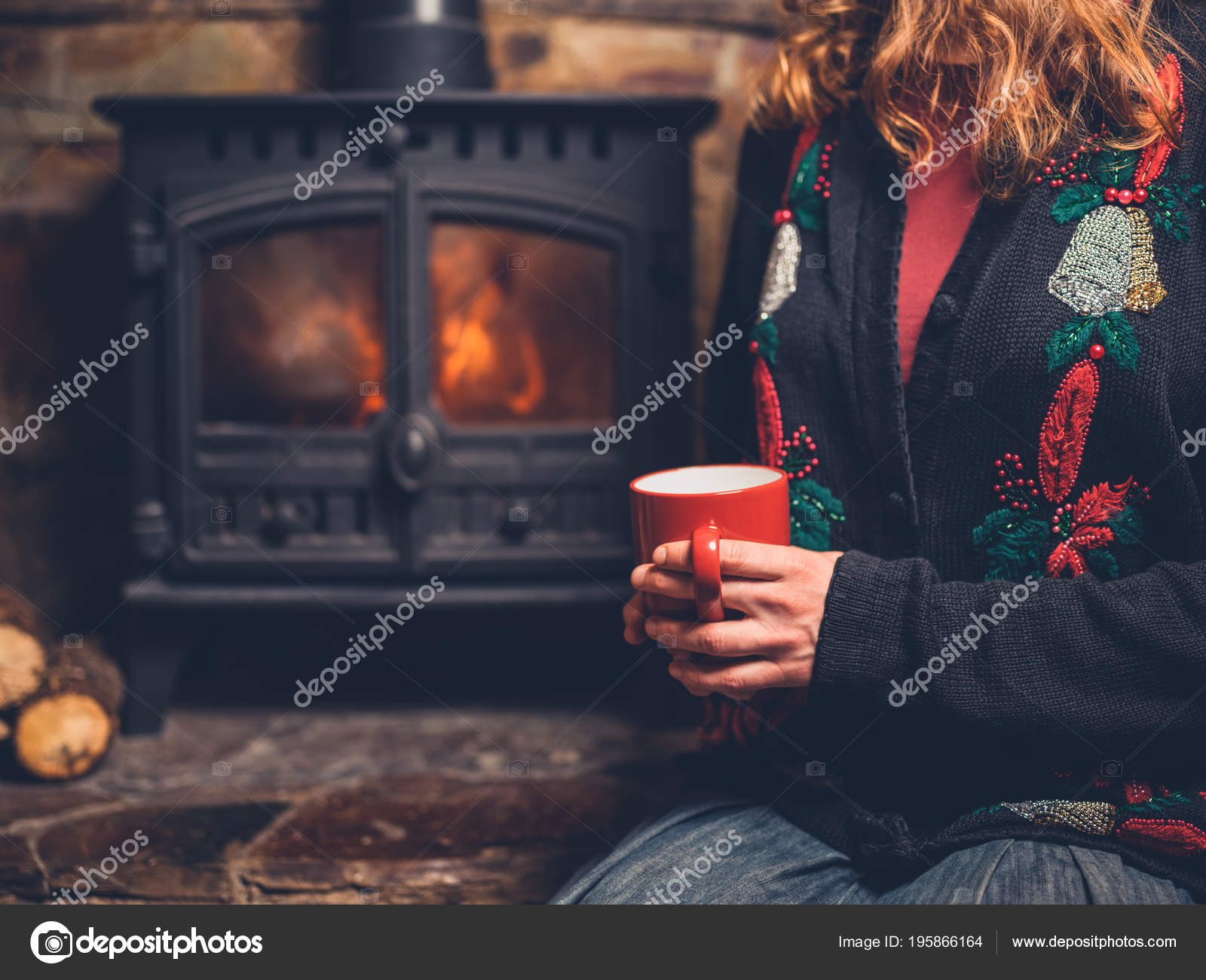 Young Woman Wearing Christmas Jumper Sitting Fire Mug Her Hand