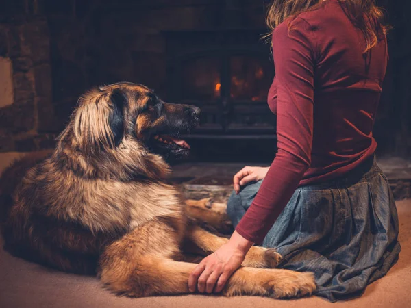 Young Woman Sitting Fire Log Burner Giant Dog — Stock Photo, Image