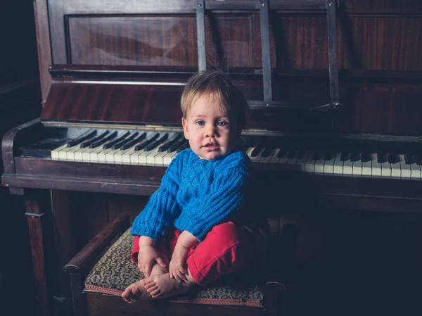 Ένα Χαριτωμένο Μικρό Αγοράκι Κάθεται Από Ένα Πιάνο — Φωτογραφία Αρχείου