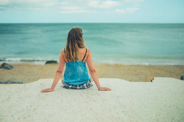 Μια Νεαρή Γυναίκα Χαλαρώνει Δίπλα Στη Θάλασσα — Φωτογραφία Αρχείου