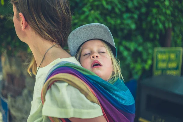 Young Mother Carrying Her Sleeping Toddler Sling Her Back — Stock Photo, Image