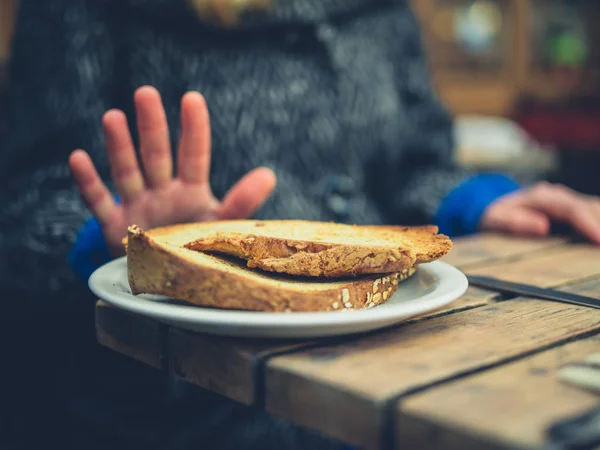 Woman on gluten free diet rejecting toast — ストック写真