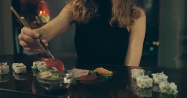 Elegant woman eating sushi — Stockvideo