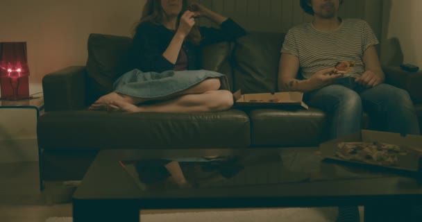 Young Man Woman Sitting Sofa Home Watching Televison Whilst Eating — Stock Video