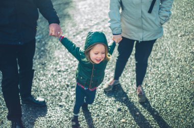 Büyükbaba ve torun kışın el ele yürüyorlar.