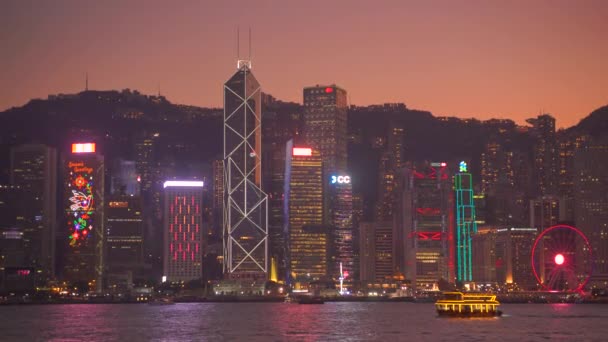 中国香港- 2019年12月06日：4k维多利亚港，夜间设有天际线及旅游船 — 图库视频影像