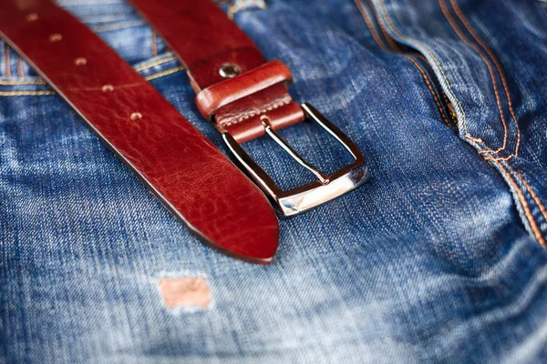 men\'s leather trouser belt in the background of denim, men\'s closet, jeans