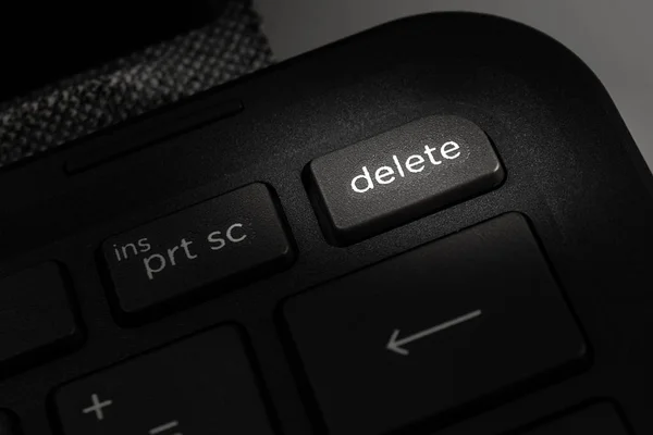 laptop computer keyboard with delete icon on the key, the concept of deleting information, cleaning the computer