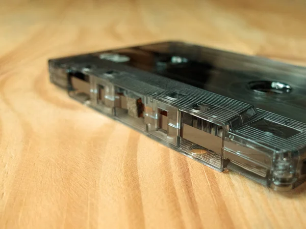 vintage old film music cassette on a wooden background, music background, music lovers, close up, macro