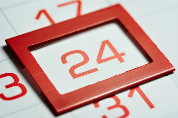 twenty-fourth of the month highlighted on the calendar with a red frame close-up macro, mark on the calendar, twenty-fourth date