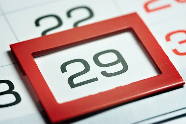 twenty-ninth of the month highlighted on the calendar with a red frame close-up macro, mark on the calendar, twenty-ninth date