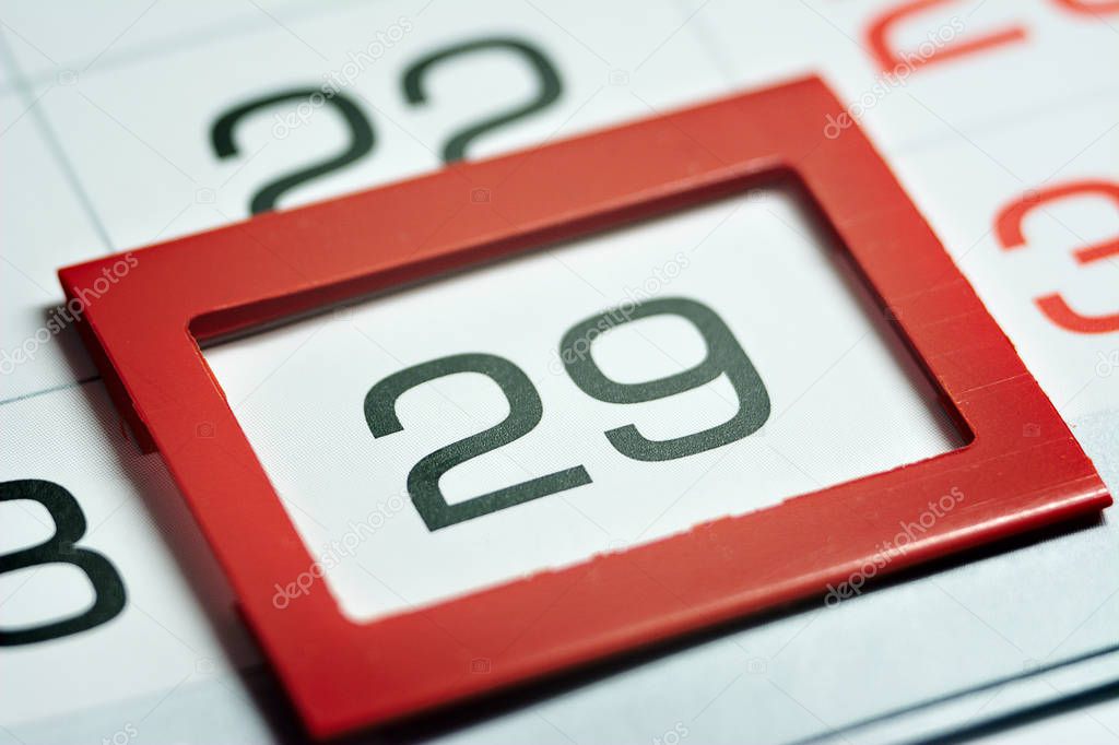 twenty-ninth of the month highlighted on the calendar with a red frame close-up macro, mark on the calendar, twenty-ninth date