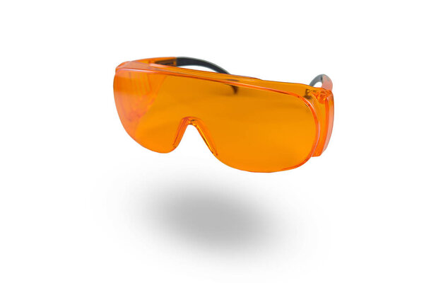 orange protective glasses in dentistry for work with UV lamp, glasses for light seals