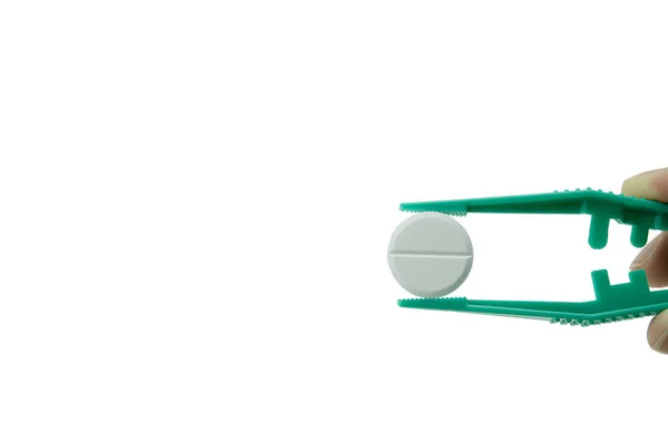 Zielone Plastikowe Pęsety Trzymające Białą Okrągłą Tabletkę Białym Tle — Zdjęcie stockowe
