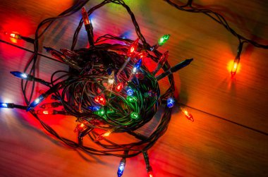 Karanlık bir odada Noel çelengi ışıkları, yanan ampuller, kış Noel havası.