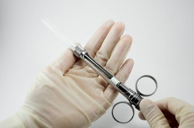 Beyaz arka planda lokal anestezi için servis şırıngası olan el doktoru.