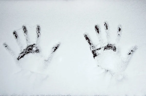 handprints in the snow