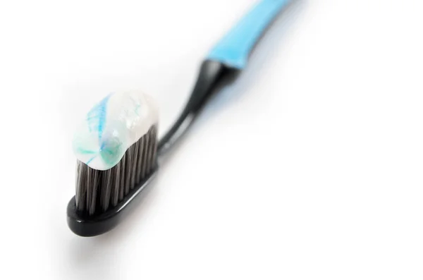 Black Toothbrush Minty Color Toothpaste Light Background — Stock Photo, Image