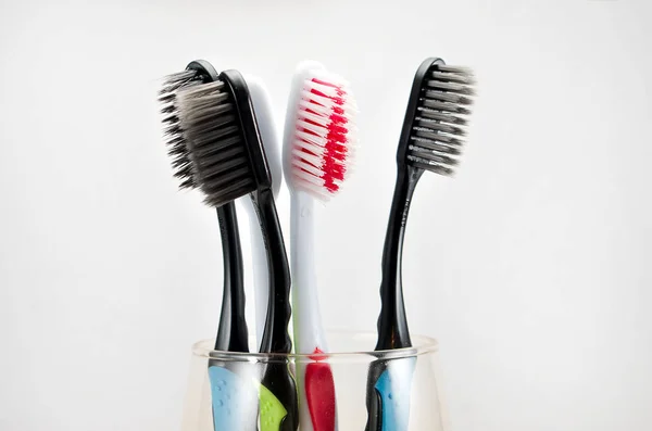 Multi Colored Toothbrushes Glass Light Background — Stock Photo, Image
