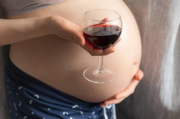 Zwangere Vrouw Met Een Glas Wijn Achtergrond Van Zwangere Buik — Stockfoto