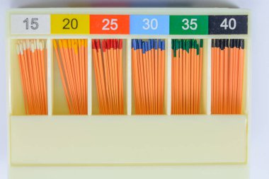 gutta-percha pins in a set of different sizes for root canal filling, material for endodontic filling, isolated, selective focus