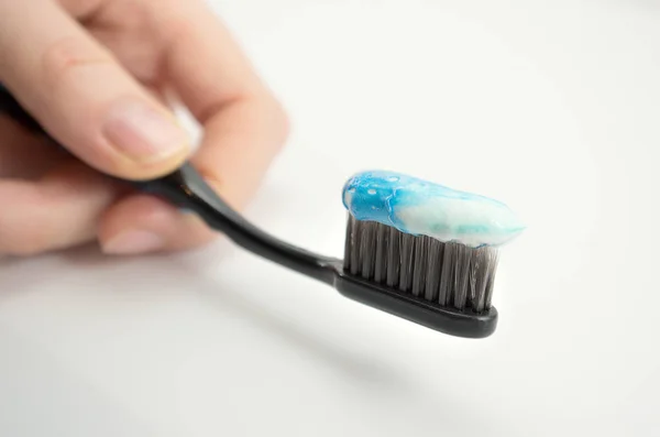 Black Toothbrush Minty Color Toothpaste Girl Hand Light Background — Stock Photo, Image