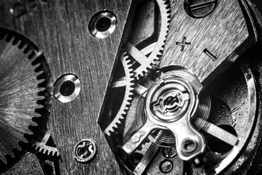 vintage old mechanism with gears and springs, clock mechanism close-up macro, black and white photo