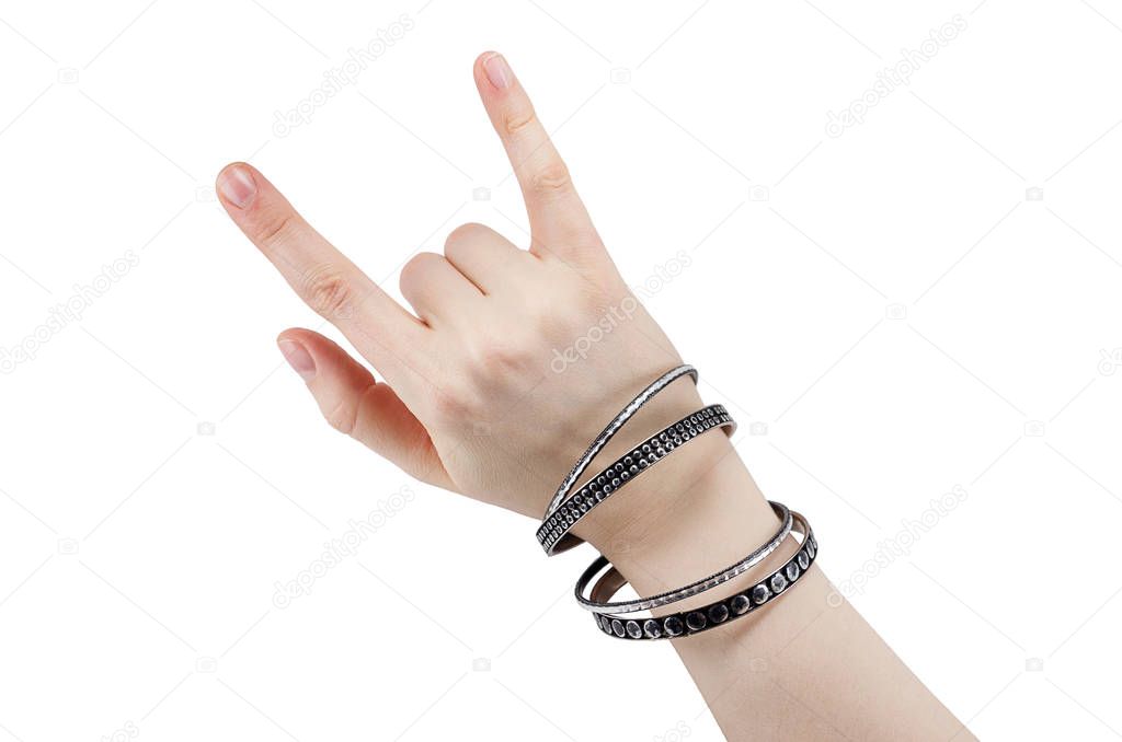hand with leather rocker bracelet with rock and roll sign, rock music isolated on white background