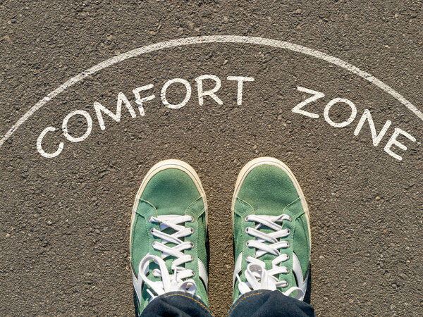 photo on top of the sneakers and the inscription comfort zone on the asphalt, the concept of personal private space