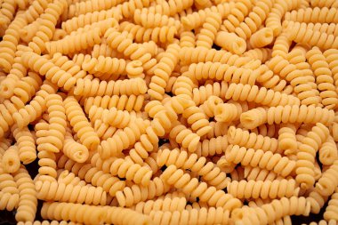 pasta from durum wheat curls fusilli, cavatappi, unprepared, raw pasta cellentani handmade on background