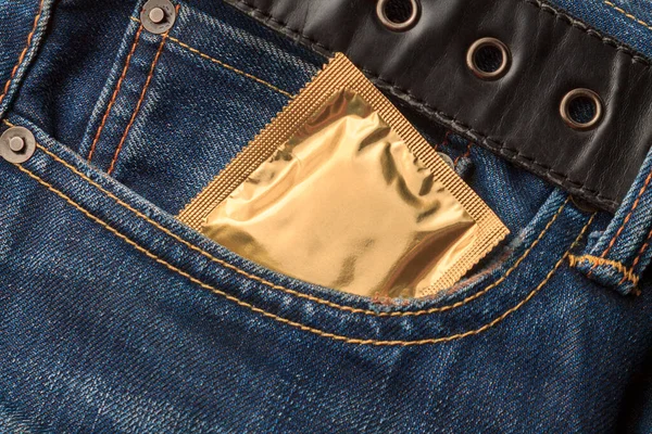 Packed condoms in the pocket of jeans, contraceptive and venereal disease prevention, prevention of HIV infection and HCV viral hepatitis, sexual education concept