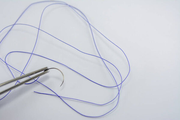 suture material close-up, thread for suturing wounds in medicine, dentistry, medical needle