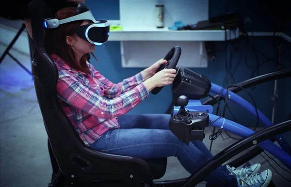 girl driving a virtual machine with virtual reality glasses, augmented reality