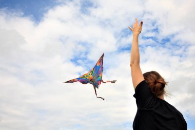 kite in hand against the blue sky in summer, flying kite launching, fun summer vacation
