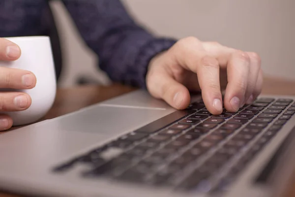 Businesswoman at the bar working on a laptop hands close up