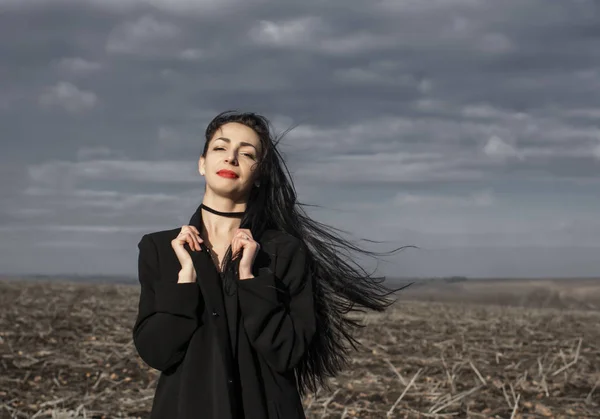 Portrait Woman Black Coat Whose Hair Flying Wind Stands Field — 스톡 사진