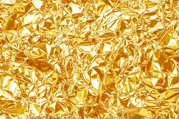 Shiny yellow gold foil texture for background and shadow. Crease