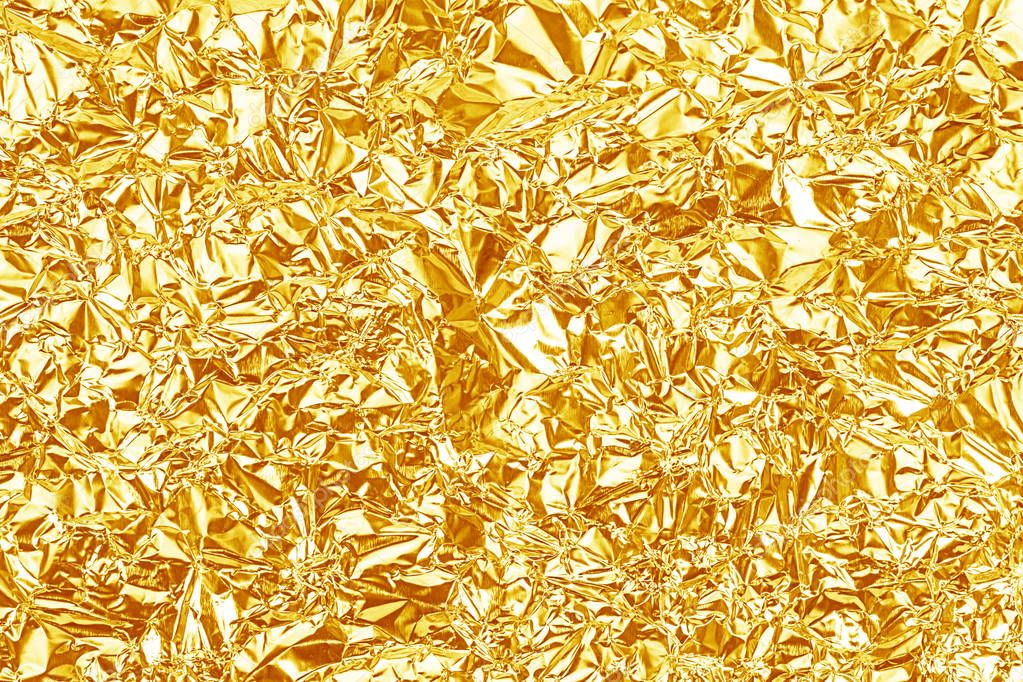 Shiny yellow gold foil texture for background and shadow. Crease Stock  Photo by ©phatthanit 129494182