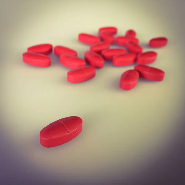 Красные таблетки на сером фоне и тени, винтажный цвет ржавчины — стоковое фото