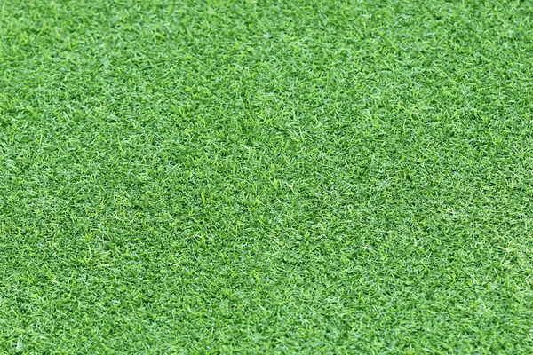Зеленая искусственная текстура травы для фона — стоковое фото