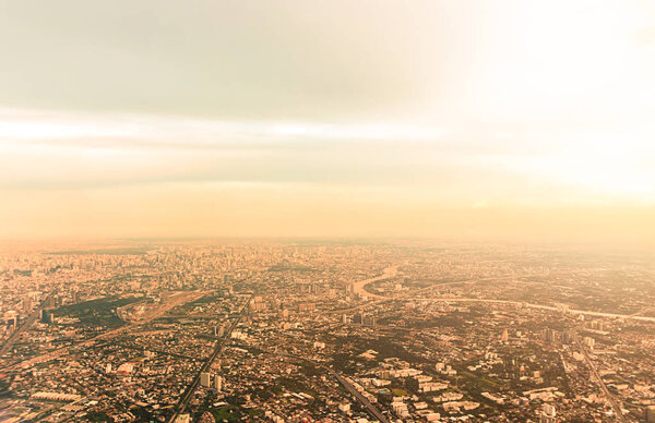 Top view Bangkok city in Thailand, at twilight time. Take a picture on airplane. Warm vintage stye color.
